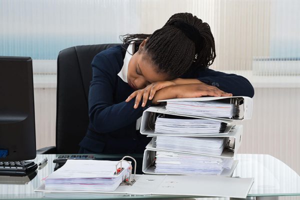 tired businesswoman sleeping at her desk